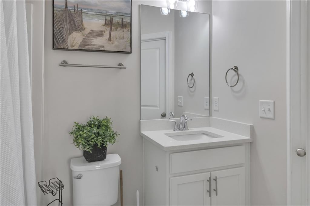 244 Wild Rose Circle Canton, GA 30115 - Photo 28 of 55 a bathroom with a toilet a sink and mirror