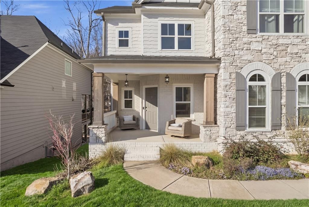 244 Wild Rose Circle Canton, GA 30115 - Photo 3 of 55 a view of a brick house with many windows and yard