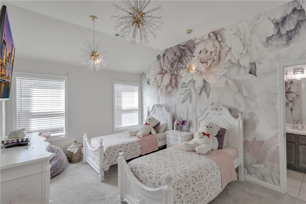 244 Wild Rose Circle Canton, GA 30115 - Photo 31 of 55 a bedroom with bed and a chandelier
