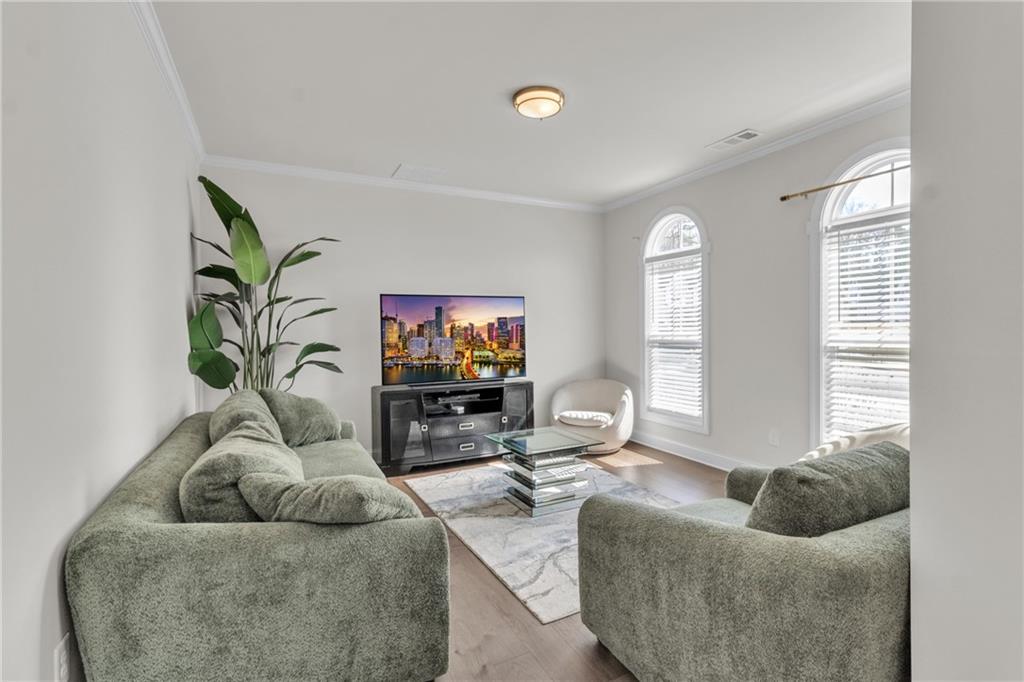244 Wild Rose Circle Canton, GA 30115 - Photo 10 of 55 a living room with furniture and a flat screen tv