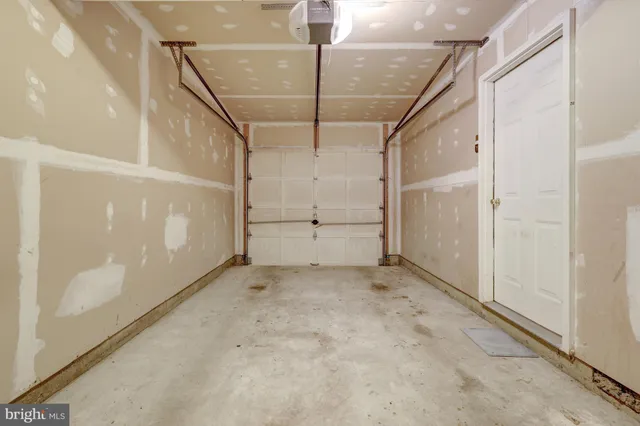 a kitchen with a refrigerator cabinets and wooden floor