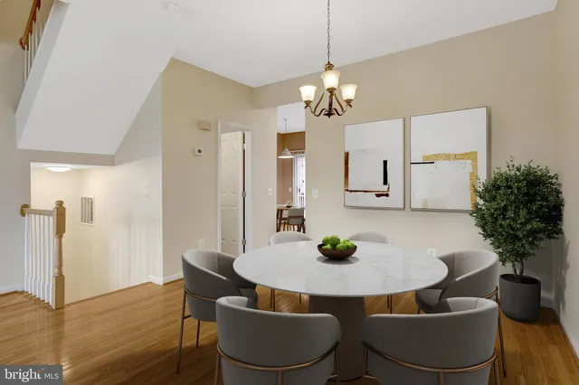 a view of a hallway with wooden floor and entryway