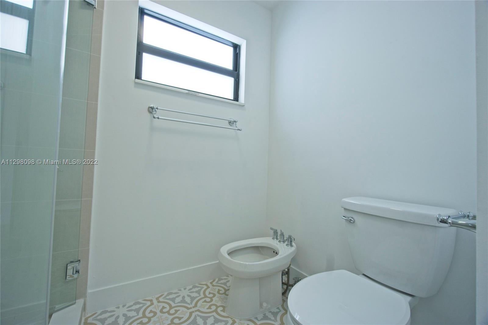434 Southwest 23rd Road Miami, FL 33129 - Photo 14 of 32 a white toilet sitting next to a window