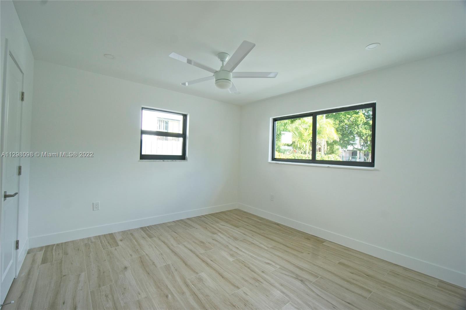 434 Southwest 23rd Road Miami, FL 33129 - Photo 15 of 32 wooden floor in an empty room with a window