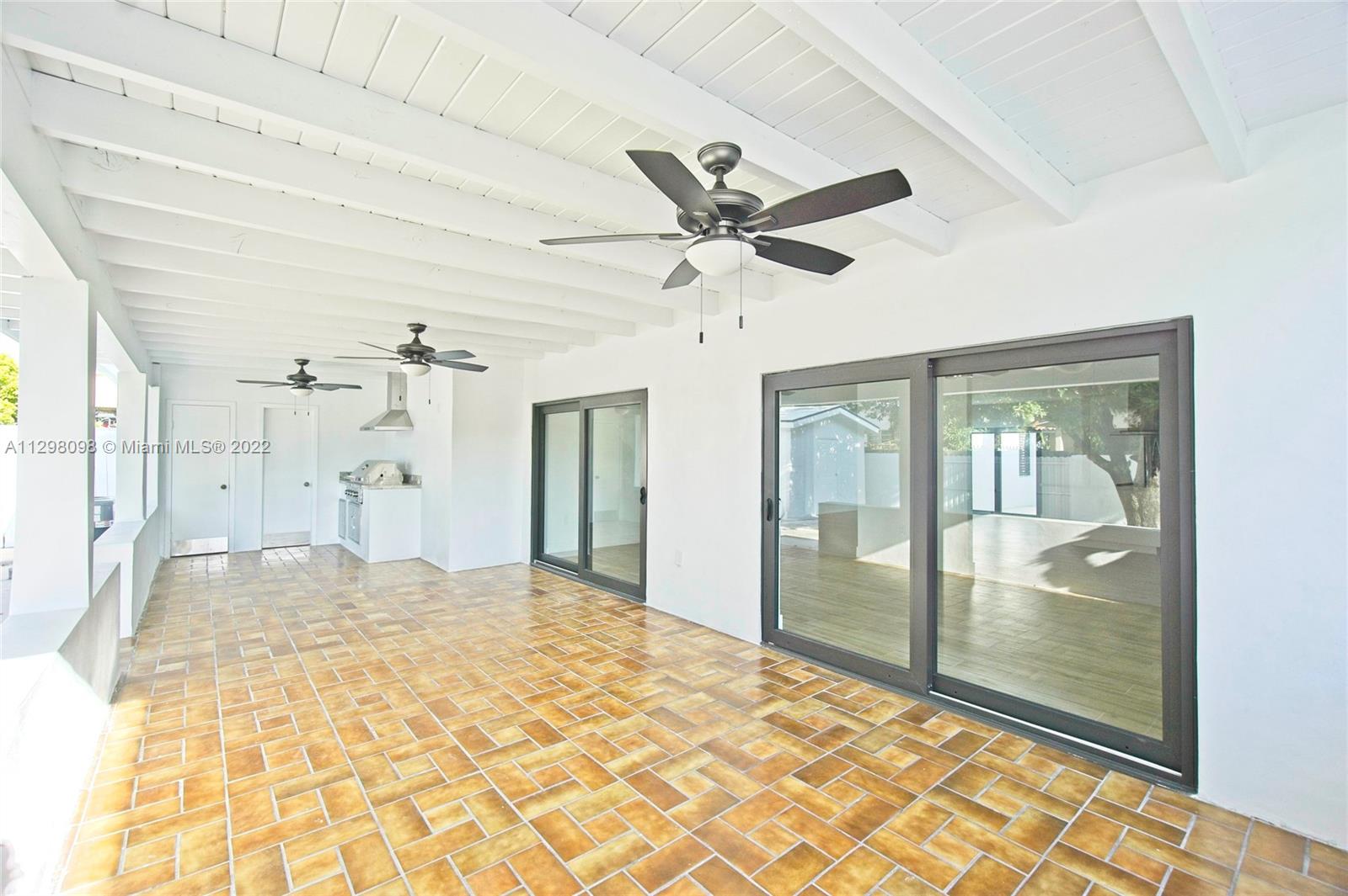 434 Southwest 23rd Road Miami, FL 33129 - Photo 23 of 32 a view of a big room with wooden floor and a ceiling fan