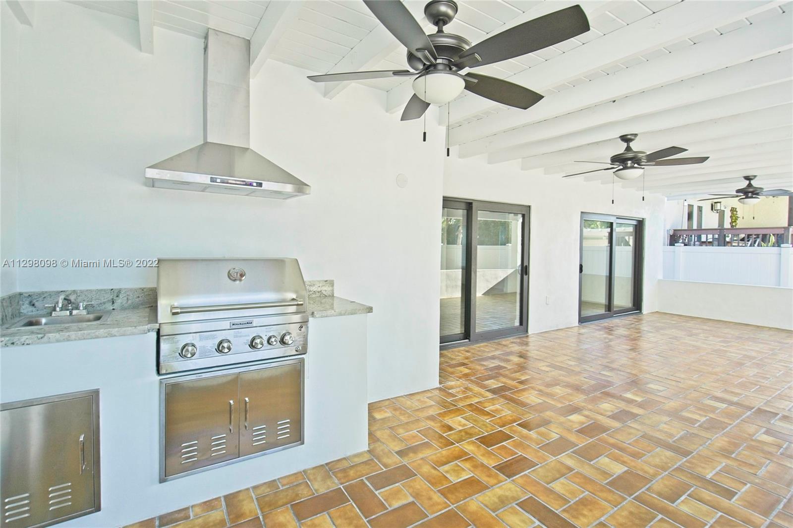 434 Southwest 23rd Road Miami, FL 33129 - Photo 25 of 32 a kitchen with a stove a sink and a refrigerator