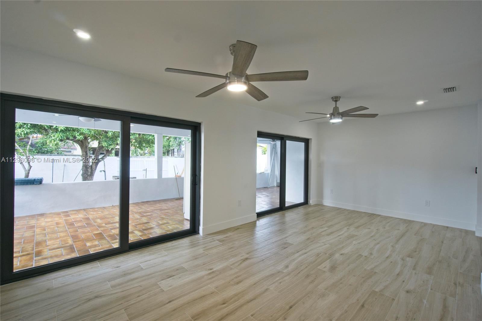 434 Southwest 23rd Road Miami, FL 33129 - Photo 8 of 32 an empty room with wooden floor and windows