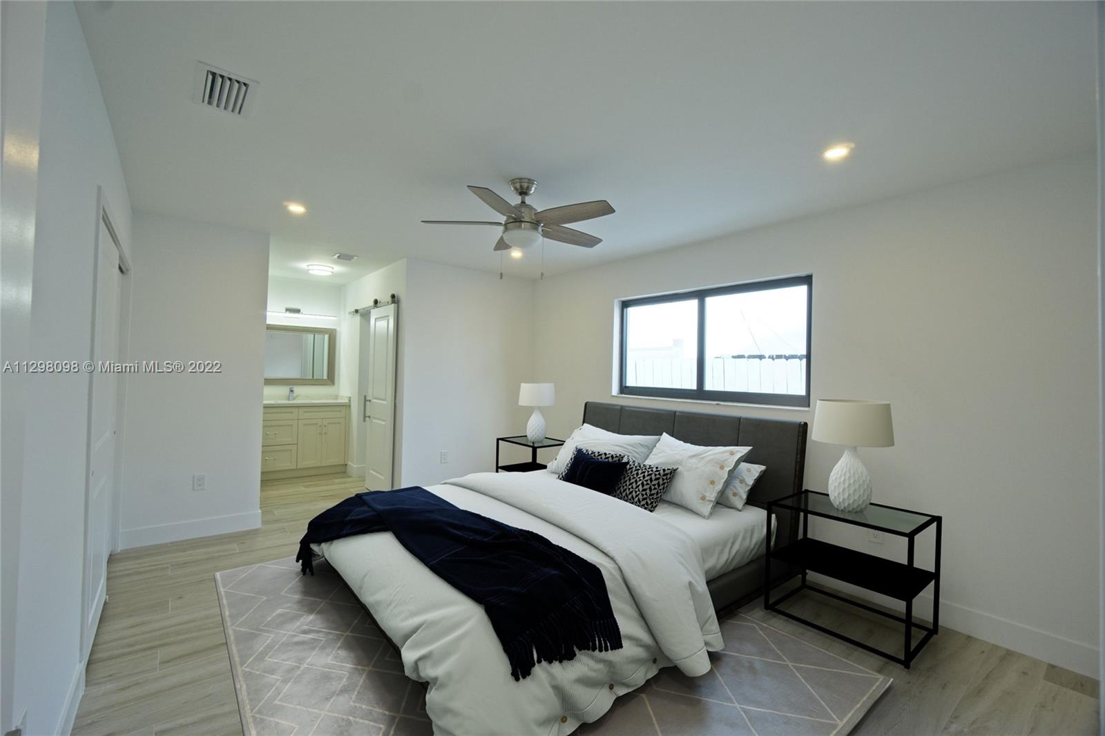 434 Southwest 23rd Road Miami, FL 33129 - Photo 9 of 32 a bedroom with a large bed window and a ceiling fan