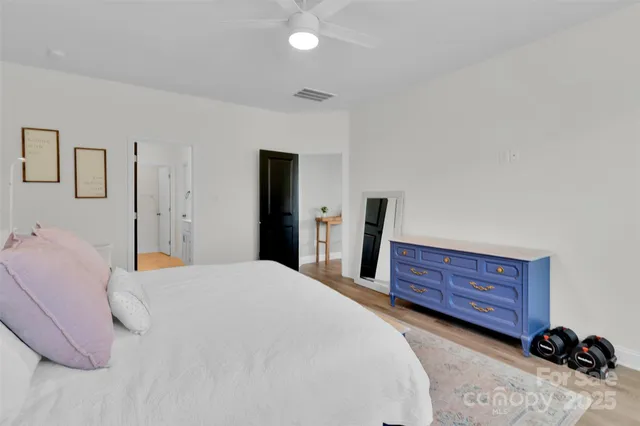 a bedroom with a bed and a dresser