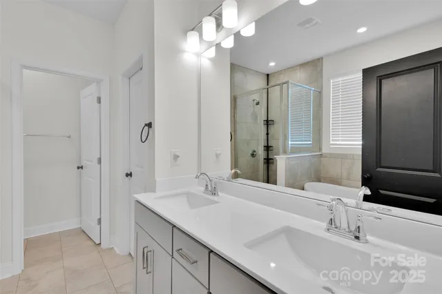 a bathroom with a sink tub and a mirror