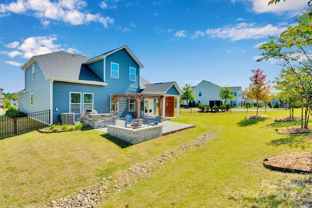 a view of a house with swimming pool and sitting area
