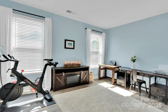 a view of a workspace with furniture and a window