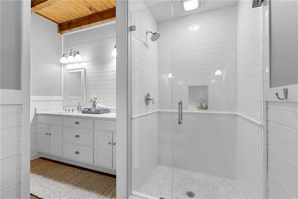 223 Denny Ridge Road Jasper, GA 30143 - Photo 18 of 54 a bathroom with a double vanity sink mirror and shower