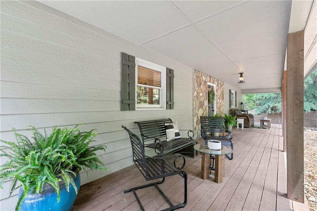 223 Denny Ridge Road Jasper, GA 30143 - Photo 2 of 54 a dining room with furniture potted plants and wooden floor