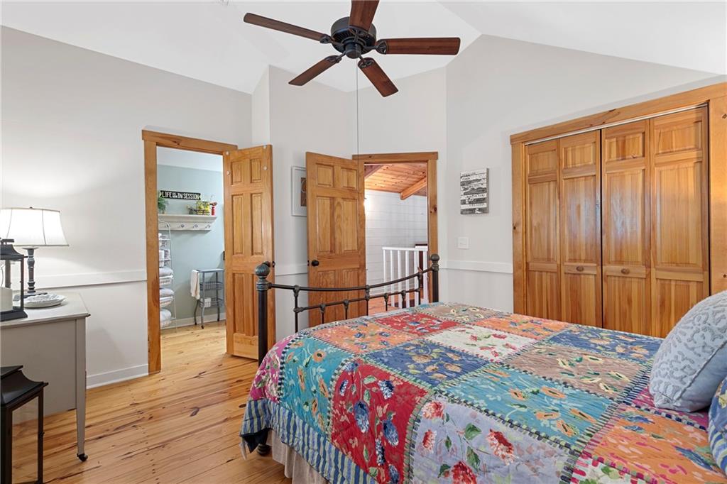 223 Denny Ridge Road Jasper, GA 30143 - Photo 21 of 54 a bedroom with a bed and a chandelier