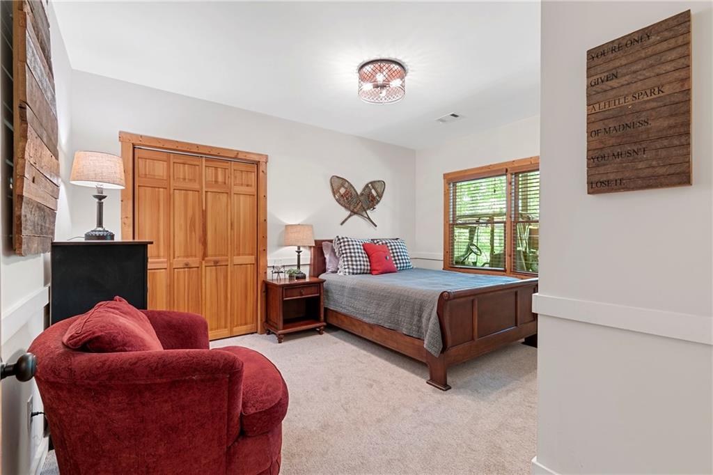 223 Denny Ridge Road Jasper, GA 30143 - Photo 24 of 54 a bedroom with a bed and a window