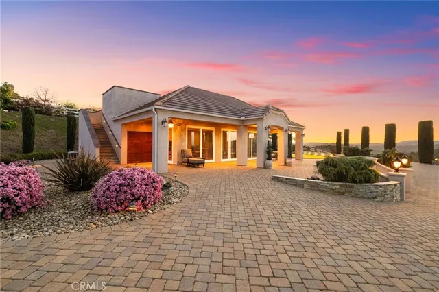a view of a house with a big yard and potted plants