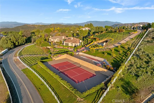 a living room with furniture a fireplace and a large window
