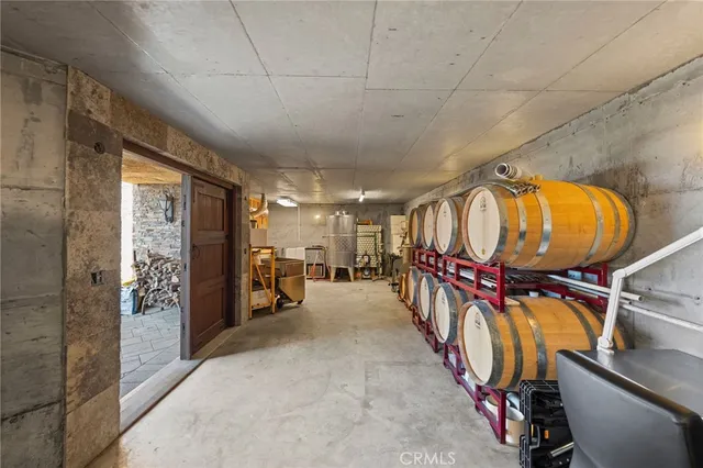 a room with stainless steel appliances furniture and a kitchen view