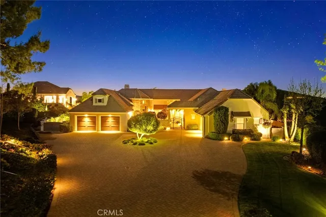 a bedroom with a bed and dresser with wooden floor