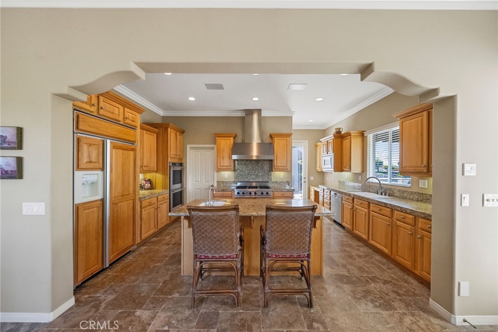 44195 Sunset Terrace Temecula, CA 92590 - Photo 27 of 74 a large kitchen with a table and chairs