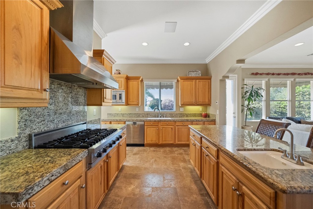 44195 Sunset Terrace Temecula, CA 92590 - Photo 28 of 74 a kitchen with stainless steel appliances granite countertop a stove a sink and a refrigerator