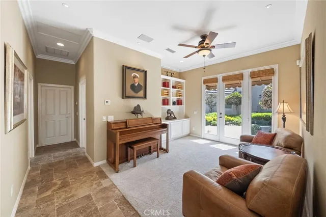 a living room with furniture ceiling fan and a rug