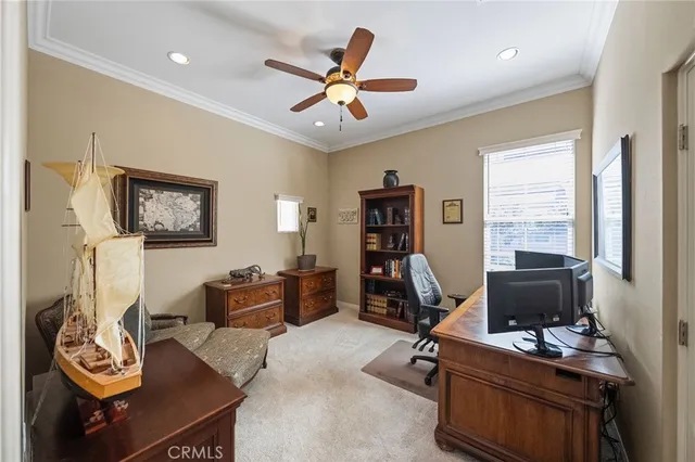 a spacious bedroom with a bed a table and a fireplace