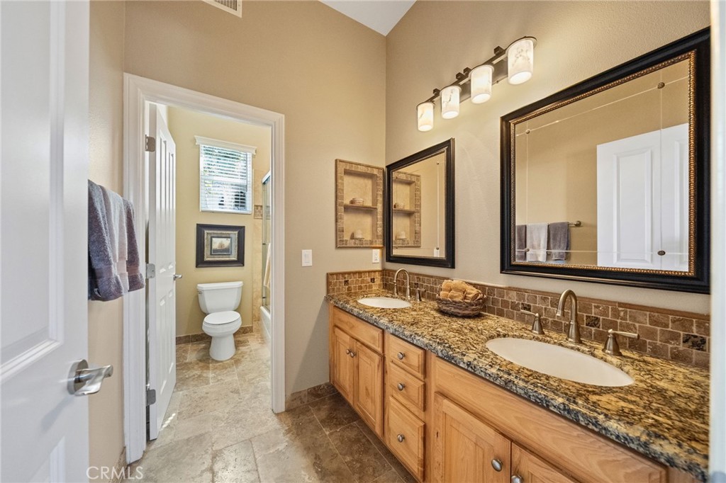 44195 Sunset Terrace Temecula, CA 92590 - Photo 34 of 74 a large bathroom with a granite countertop sink and a mirror