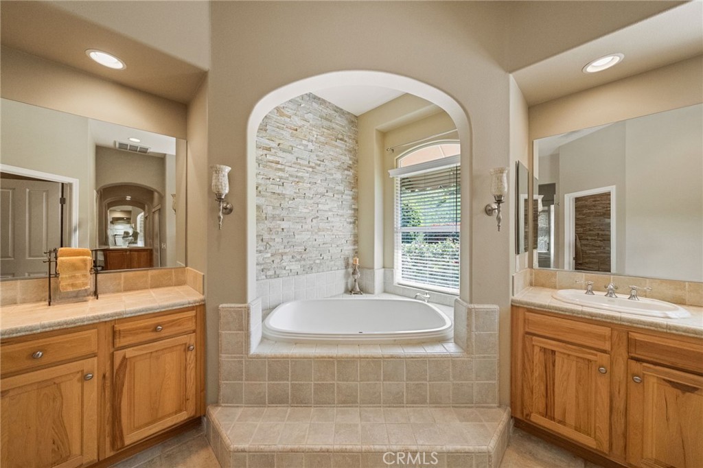 44195 Sunset Terrace Temecula, CA 92590 - Photo 36 of 74 a spacious bathroom with a tub sink and mirror