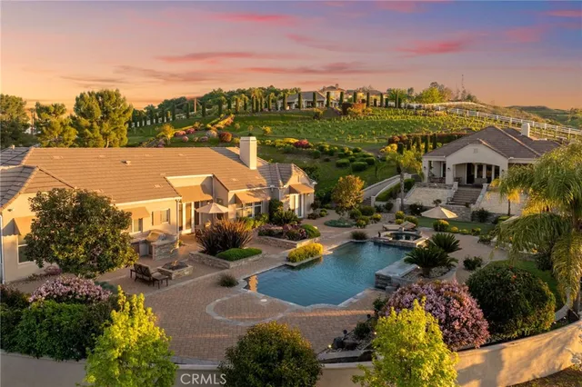 an aerial view of a house with a swimming pool