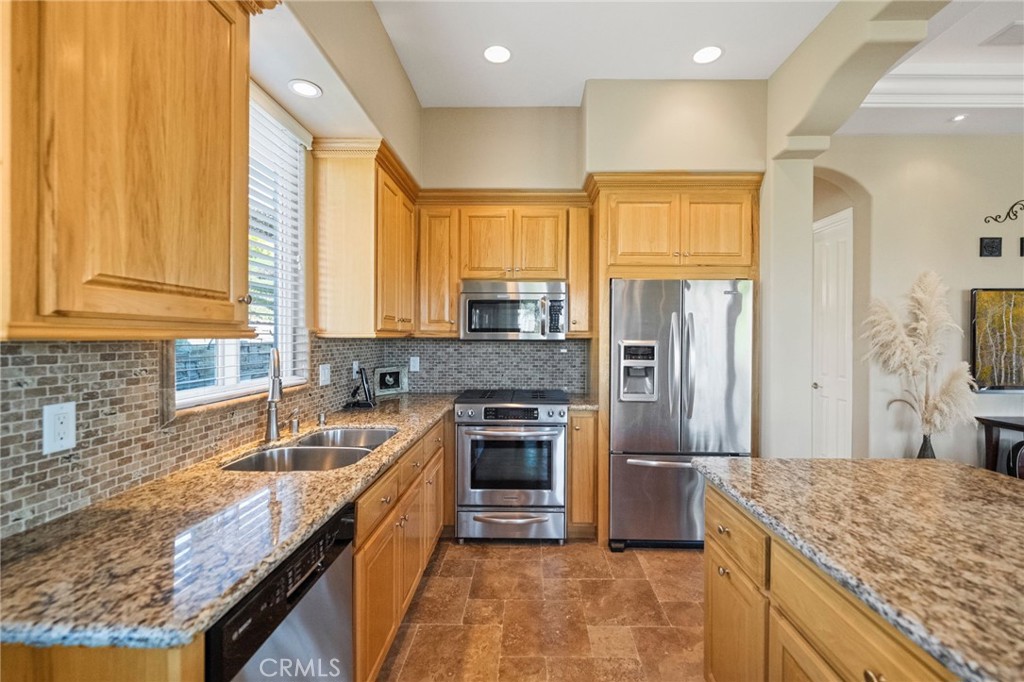 44195 Sunset Terrace Temecula, CA 92590 - Photo 47 of 74 a kitchen with stainless steel appliances granite countertop a sink a stove and a refrigerator
