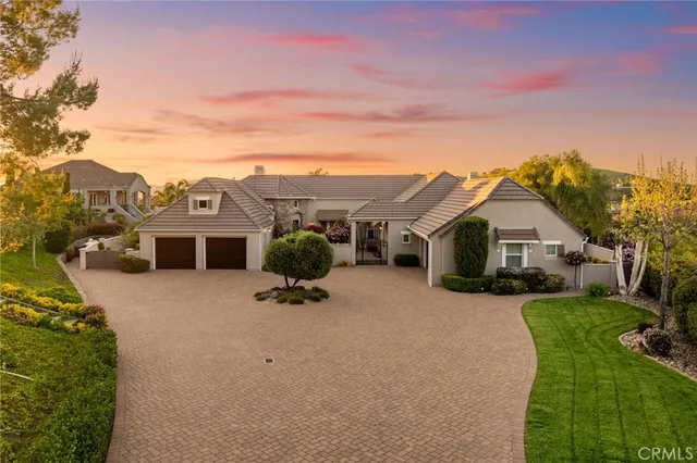 a view of a house with pool and chairs