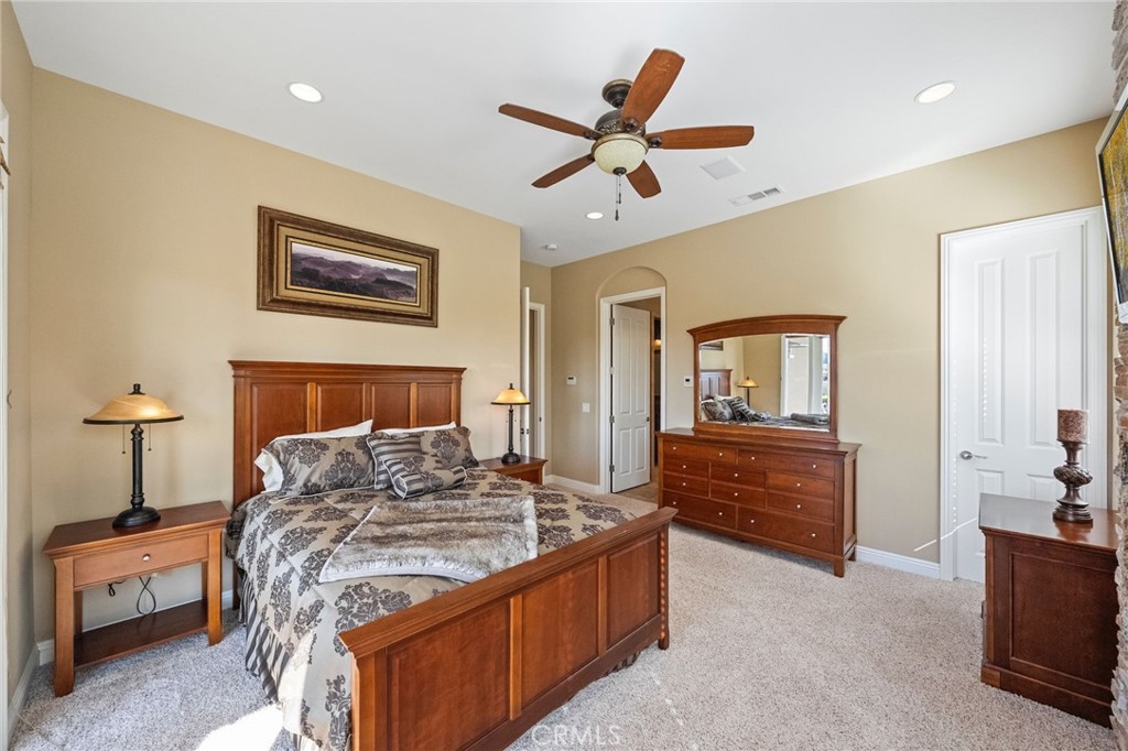 44195 Sunset Terrace Temecula, CA 92590 - Photo 52 of 74 a bedroom with a bed and a chandelier