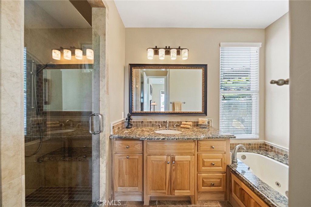 44195 Sunset Terrace Temecula, CA 92590 - Photo 53 of 74 a bathroom with a granite countertop sink and a mirror