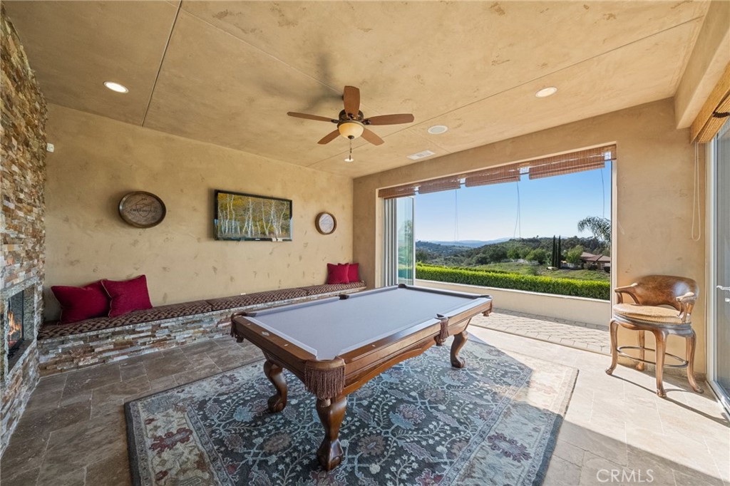 44195 Sunset Terrace Temecula, CA 92590 - Photo 54 of 74 a living room with pool table furniture and a floor to ceiling window