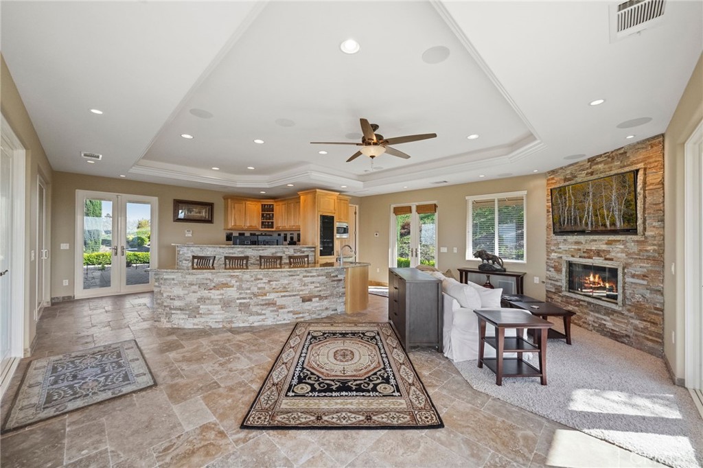 44195 Sunset Terrace Temecula, CA 92590 - Photo 61 of 74 a living room with furniture a flat screen tv and a fireplace