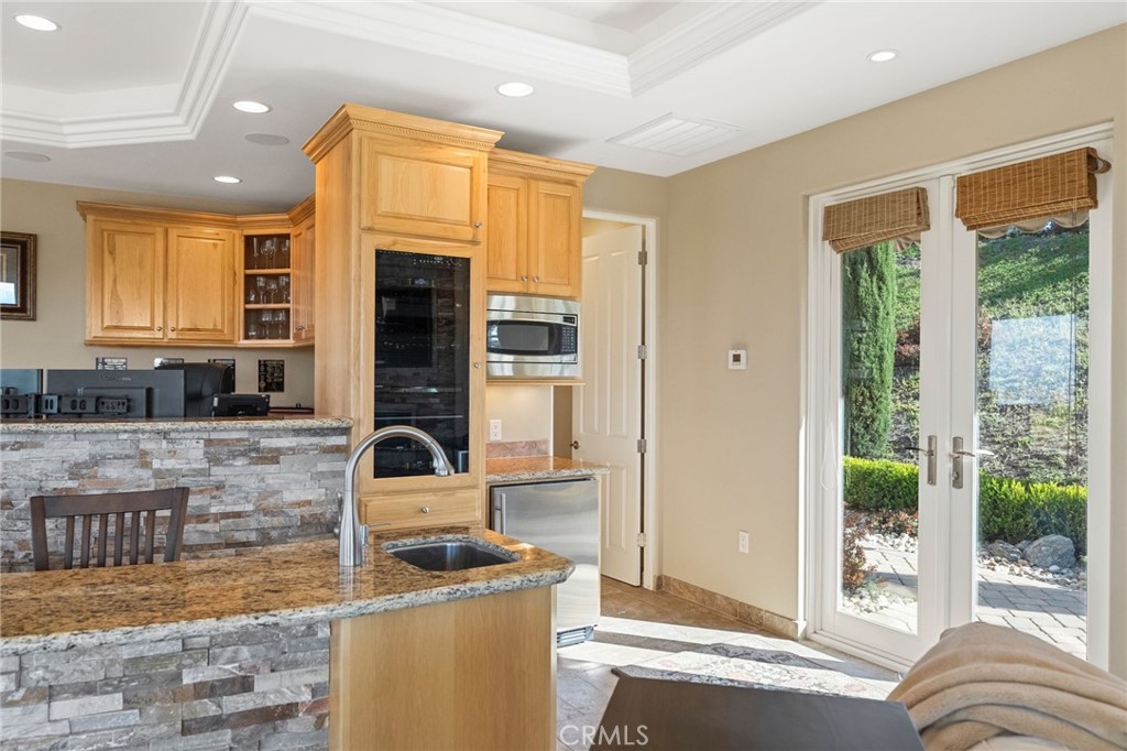 44195 Sunset Terrace Temecula, CA 92590 - Photo 62 of 74 a kitchen with a stove a sink and a refrigerator
