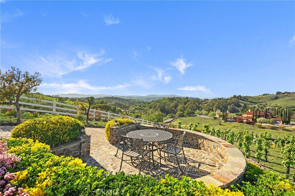 44195 Sunset Terrace Temecula, CA 92590 - Photo 67 of 74 a view of a swimming pool with a table and chairs