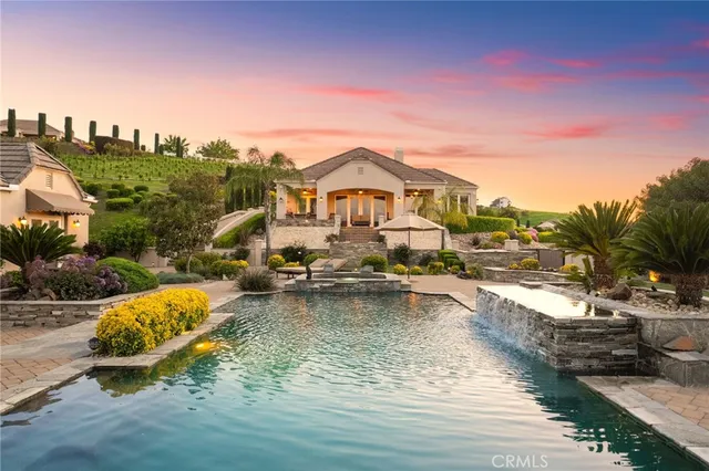 a view of a swimming pool with an outdoor space and seating area
