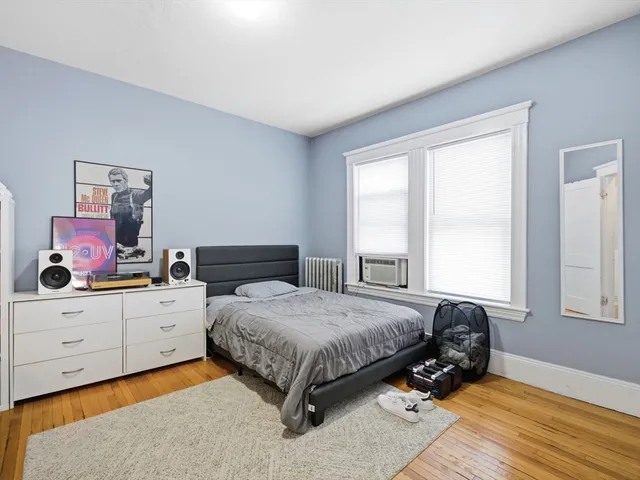 a bedroom with a bed and a desk