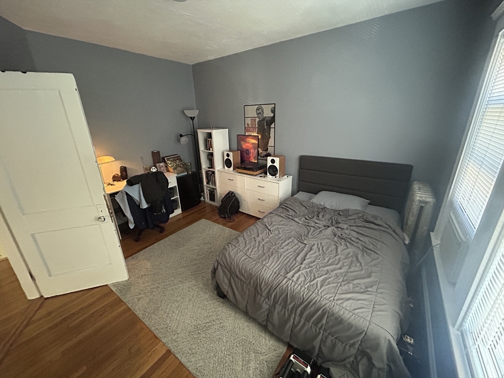 28 Sunset Road, Unit 1 Somerville, MA 02144 - Photo 14 of 15 a bedroom with a bed and wooden floor