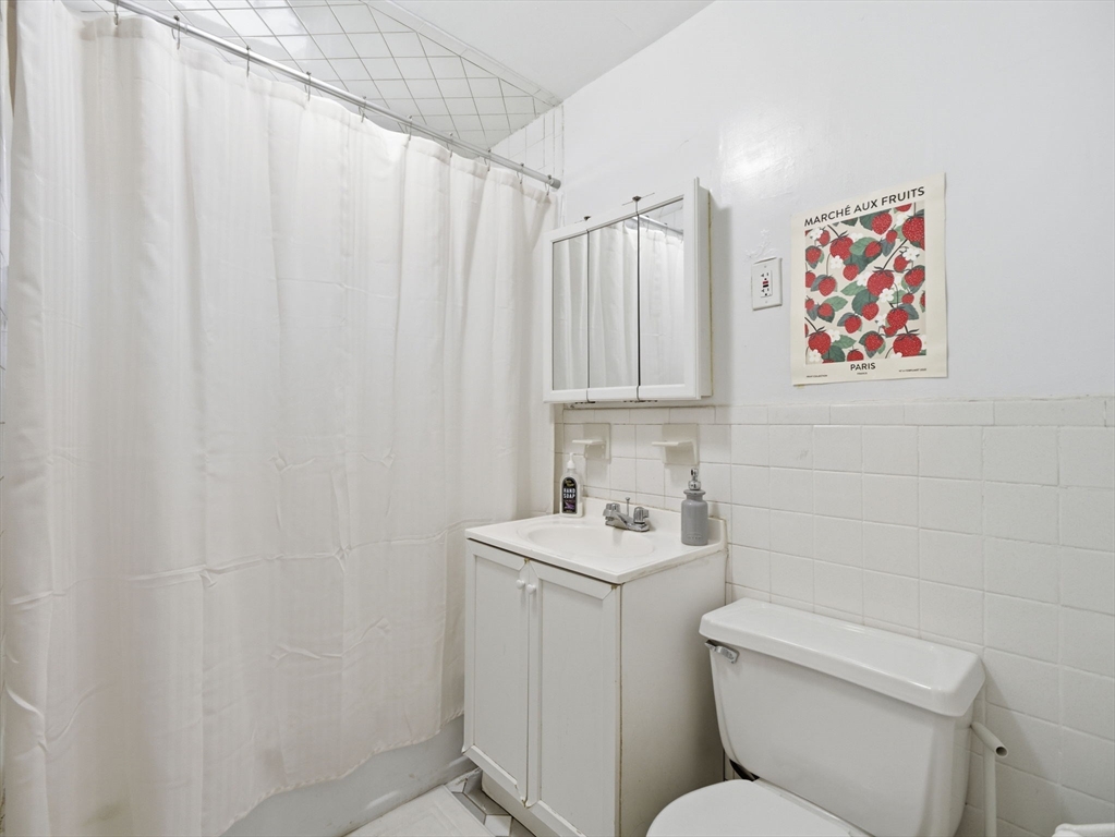 28 Sunset Road, Unit 1 Somerville, MA 02144 - Photo 15 of 33 a bathroom with a toilet sink and vanity