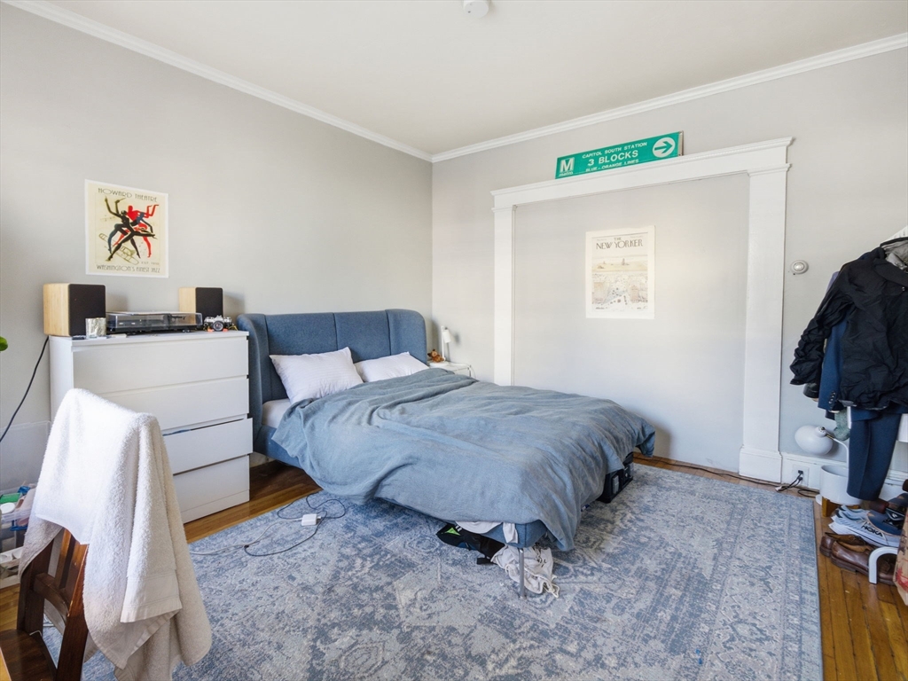28 Sunset Road, Unit 1 Somerville, MA 02144 - Photo 17 of 33 a bedroom with a bed and a tv in it