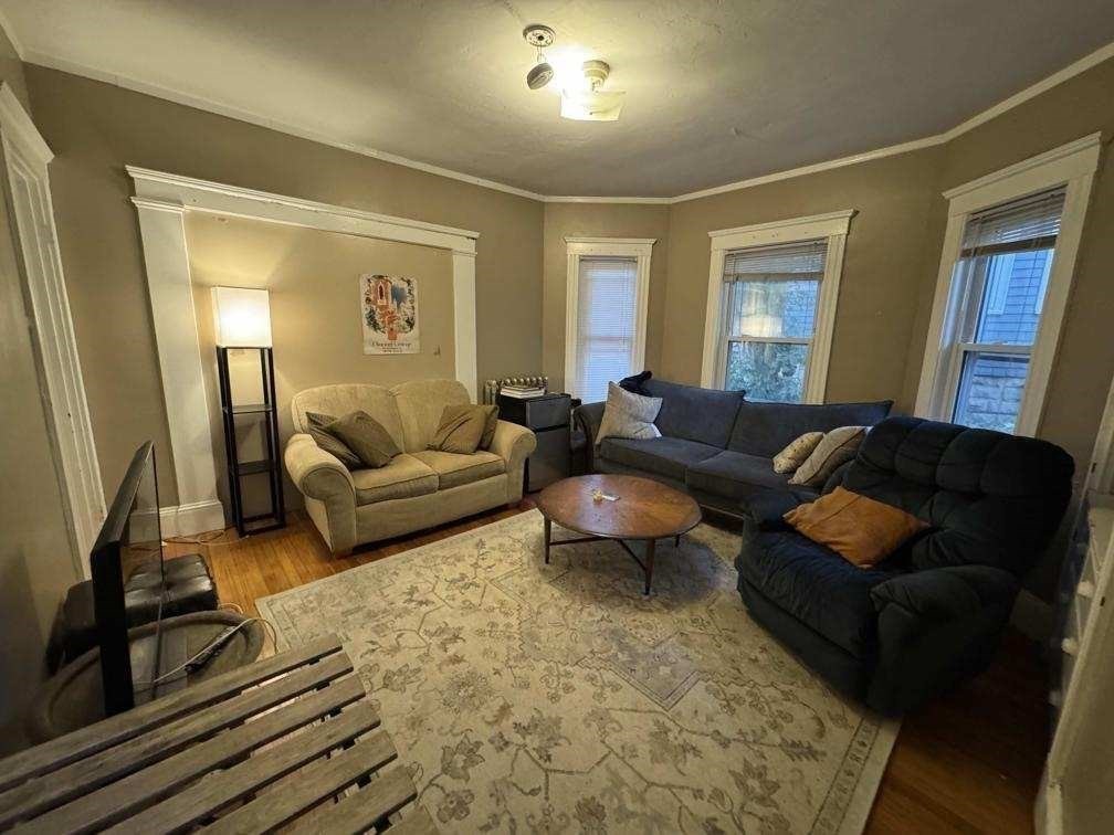 28 Sunset Road, Unit 1 Somerville, MA 02144 - Photo 2 of 15 a living room with furniture and a flat screen tv