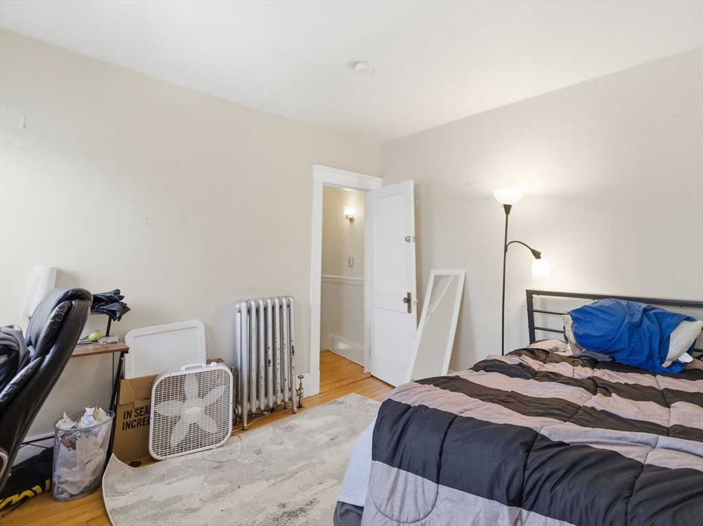 28 Sunset Road, Unit 1 Somerville, MA 02144 - Photo 22 of 33 a bedroom with a bed and wooden floor