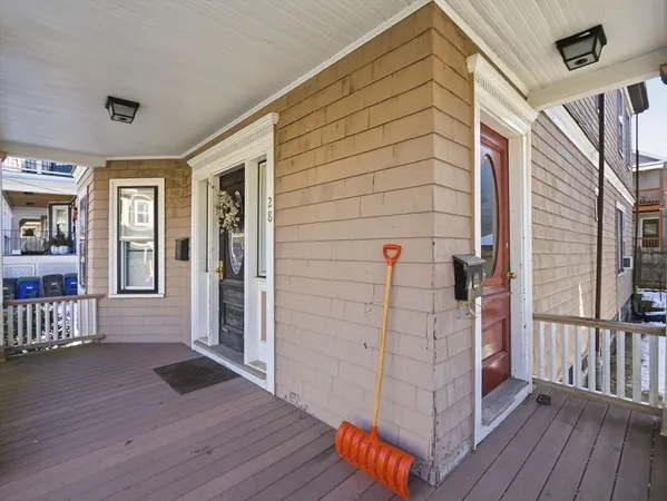 a view of a porch with wooden floor and iron stairs