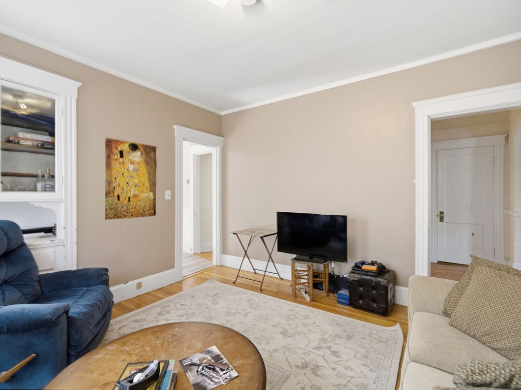 28 Sunset Road, Unit 1 Somerville, MA 02144 - Photo 4 of 33 a living room with furniture and a flat screen tv