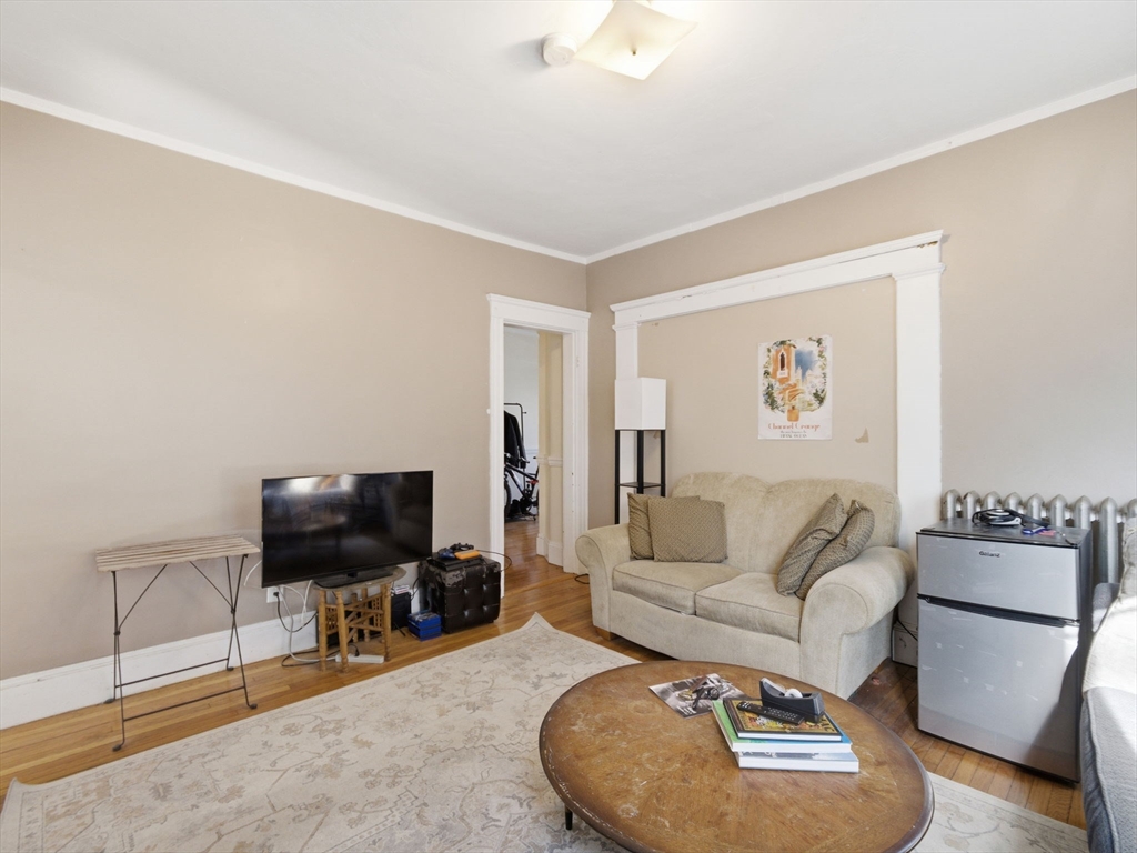 28 Sunset Road, Unit 1 Somerville, MA 02144 - Photo 5 of 33 a living room with furniture and a flat screen tv