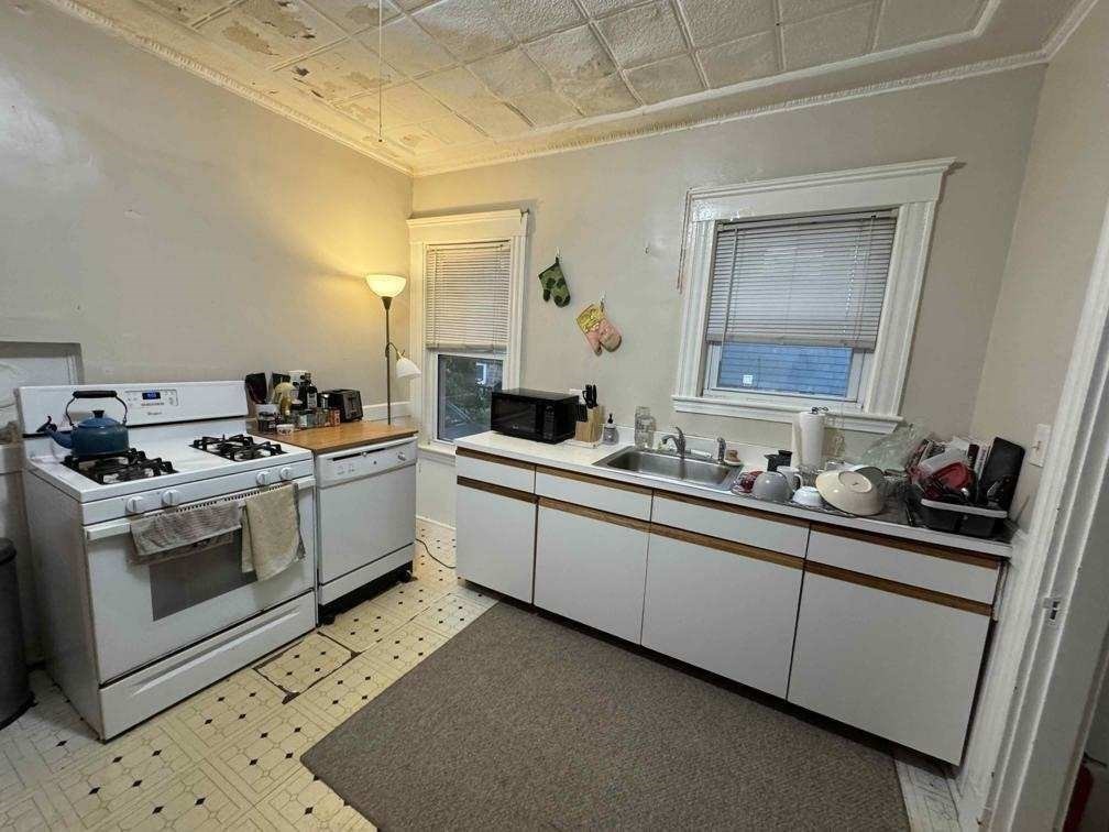 28 Sunset Road, Unit 1 Somerville, MA 02144 - Photo 6 of 15 a kitchen with a sink and cabinets